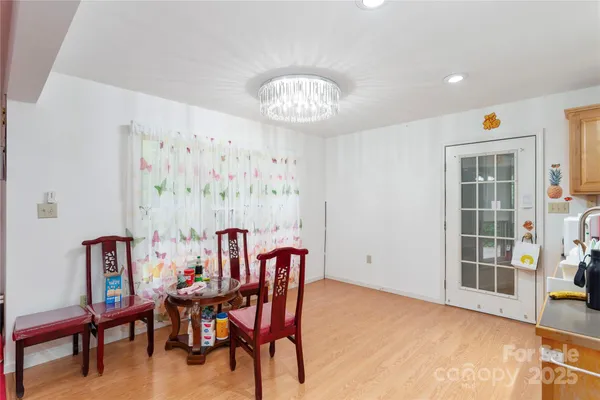 a view of a dining room with furniture and a potted plant