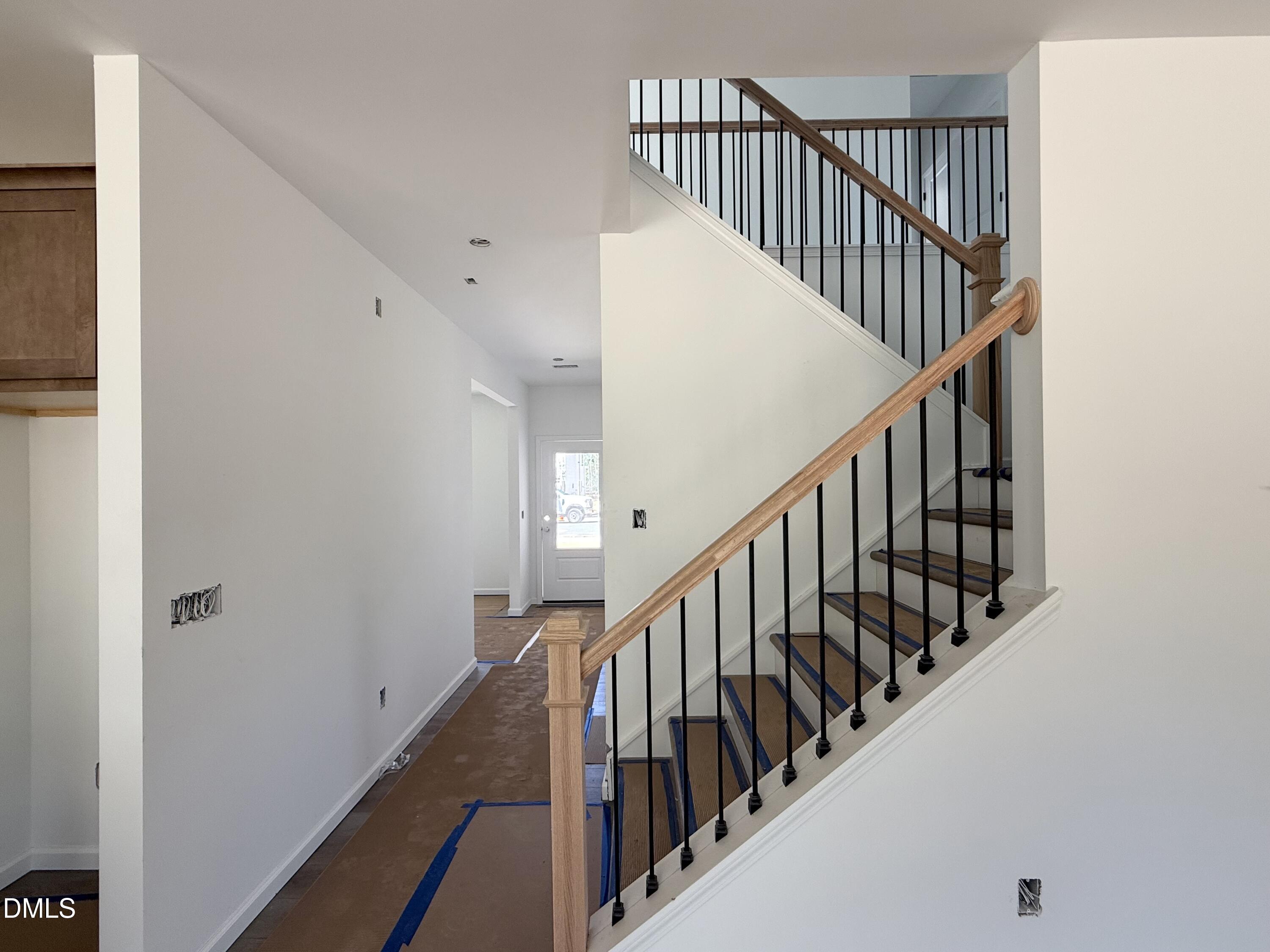 941 Fetching Place, Unit 370 Rolesville, NC 27571 - Photo 13 of 24 a view of staircase with wooden floor and white walls