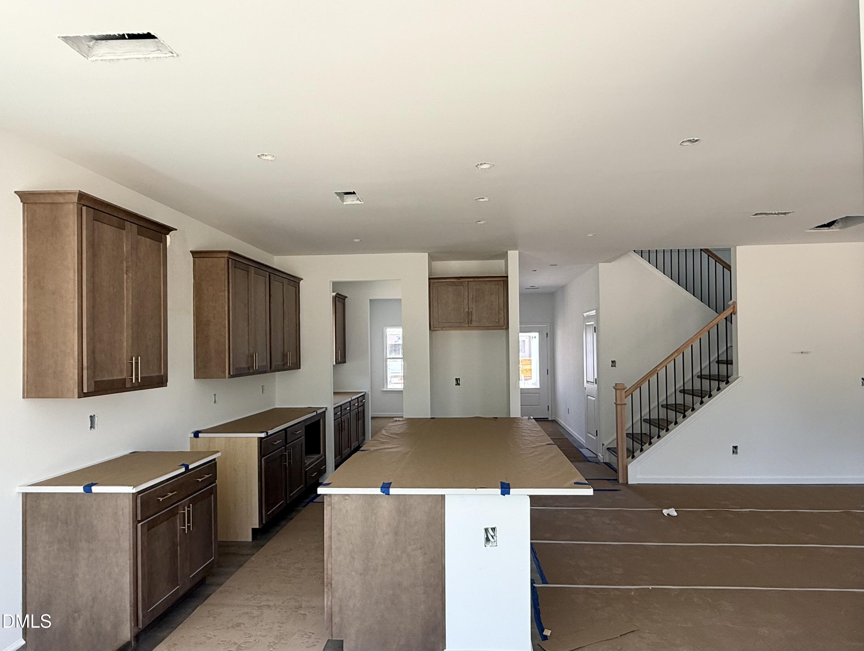 941 Fetching Place, Unit 370 Rolesville, NC 27571 - Photo 4 of 24 a utility room with stainless steel appliances wooden floor and view living room