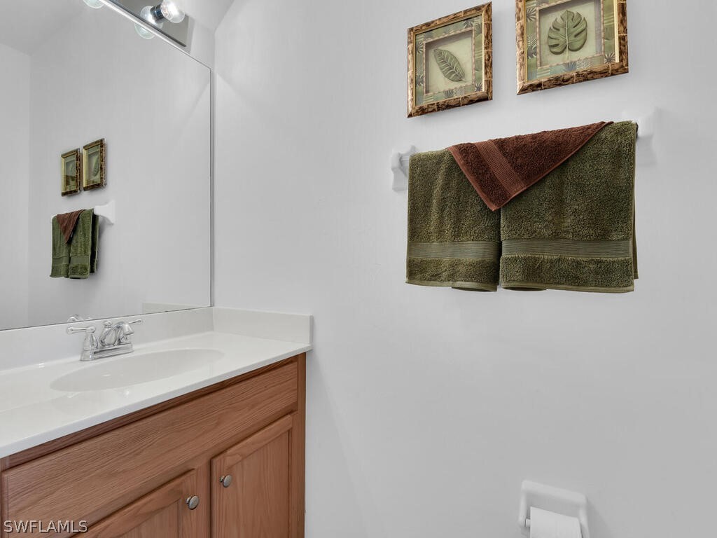 11740 Eros Road Lehigh Acres, FL 33971 - Photo 11 of 30 a bathroom with a sink and a mirror
