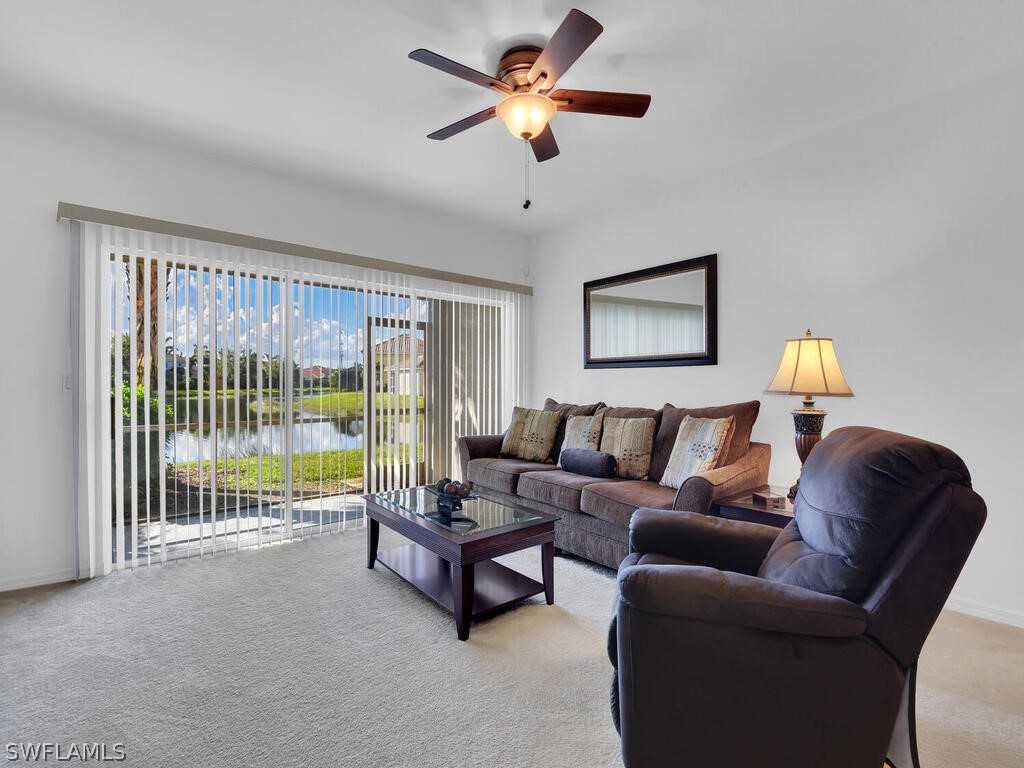 11740 Eros Road Lehigh Acres, FL 33971 - Photo 14 of 30 a living room with furniture and a large window