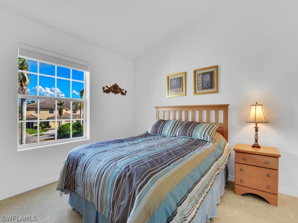11740 Eros Road Lehigh Acres, FL 33971 - Photo 20 of 30 a bedroom with a bed and a window