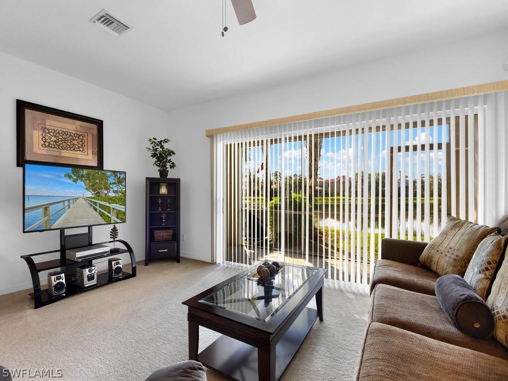 11740 Eros Road Lehigh Acres, FL 33971 - Photo 2 of 30 a living room with furniture and a floor to ceiling window