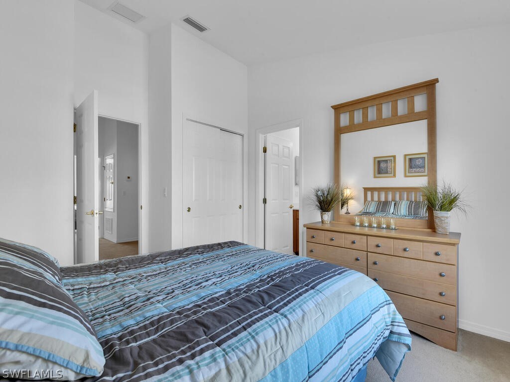 11740 Eros Road Lehigh Acres, FL 33971 - Photo 21 of 30 a bedroom with a bed and a dresser