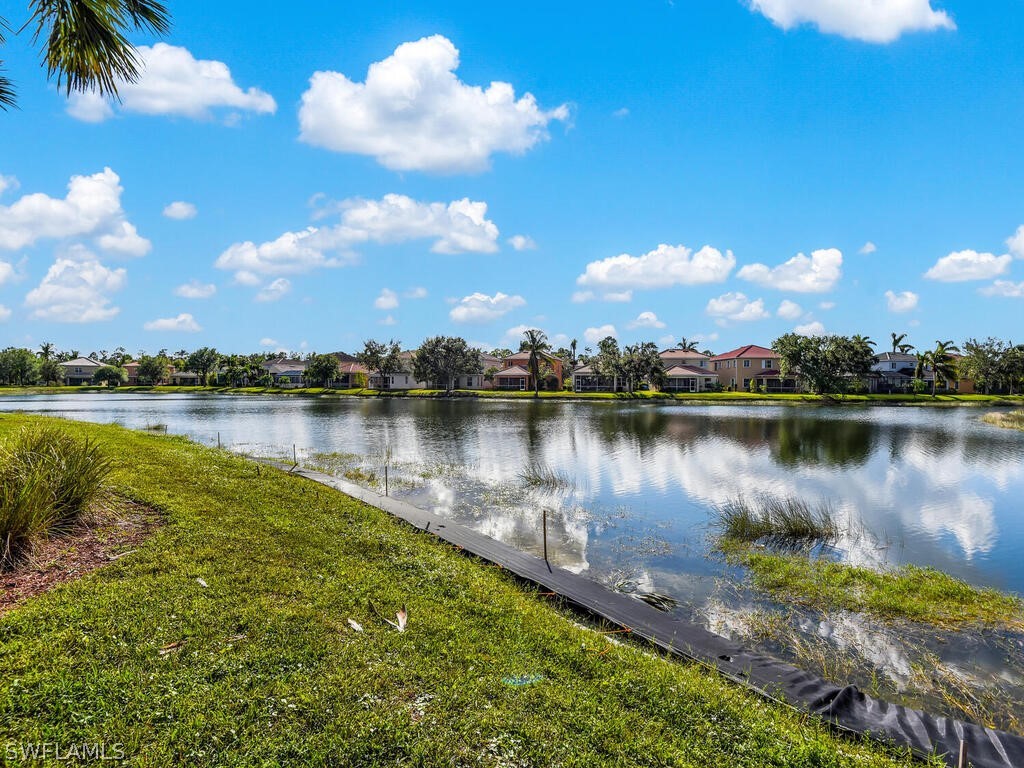 11740 Eros Road Lehigh Acres, FL 33971 - Photo 24 of 30 a view of a lake with houses in the background