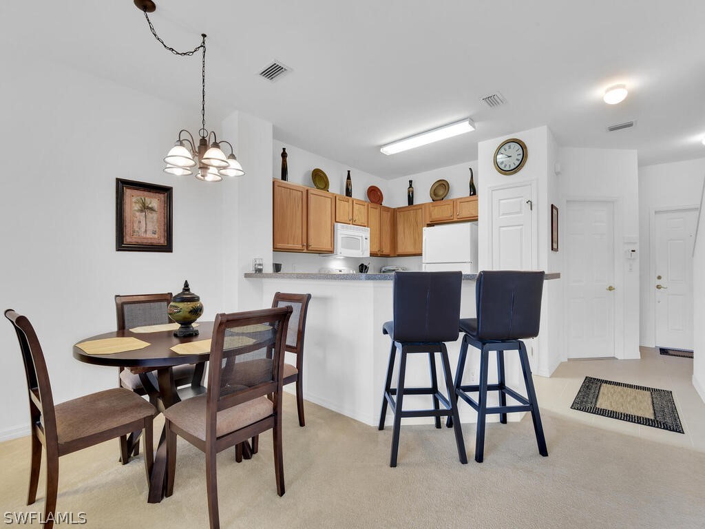 11740 Eros Road Lehigh Acres, FL 33971 - Photo 6 of 30 a view of a dining room with furniture