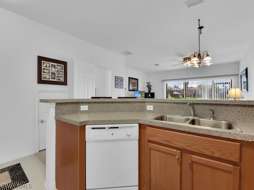 11740 Eros Road Lehigh Acres, FL 33971 - Photo 10 of 30 a kitchen with a sink and a refrigerator