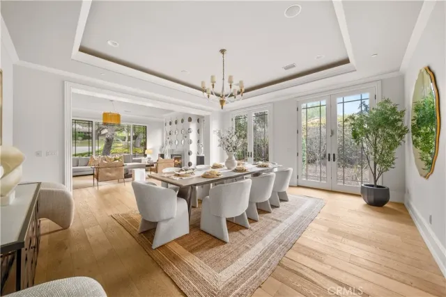 a living room with furniture wooden floor and a chandelier