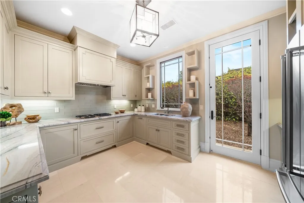 930 Fallen Leaf Road Arcadia, CA 91006 - Photo 21 of 63 a large white kitchen with cabinets a sink a window and stainless steel appliances