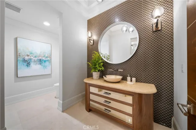 a view of cabinets with a sink and mirror