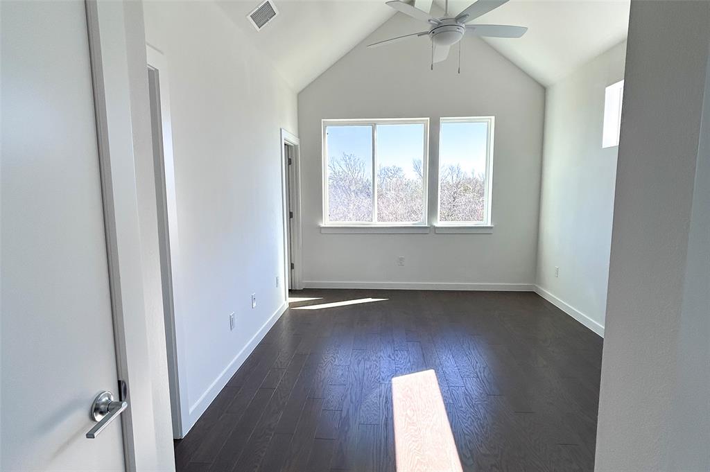 1191 Sarabeth Way Austin, TX 78721 - Photo 8 of 13 an empty room with wooden floor and windows