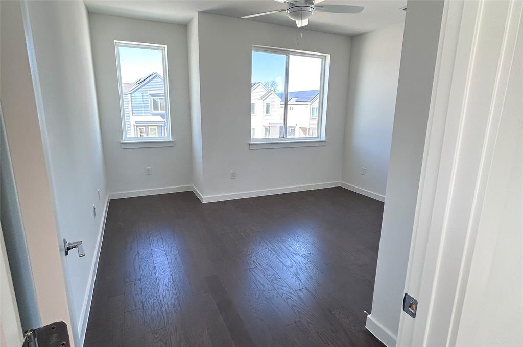 1191 Sarabeth Way Austin, TX 78721 - Photo 9 of 13 an empty room with wooden floor and windows