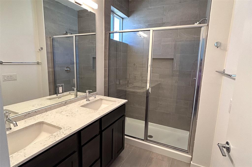 1191 Sarabeth Way Austin, TX 78721 - Photo 10 of 13 a bathroom with a granite countertop sink toilet and shower