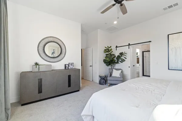 a living room with furniture a flat screen tv and a large window