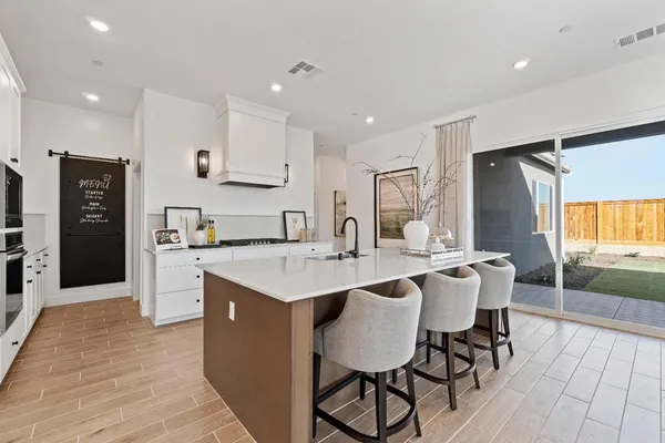 a large kitchen with a table and chairs in it