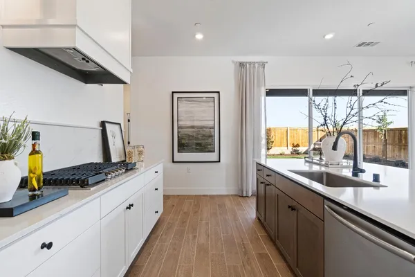 a kitchen with sink a counter space and appliances