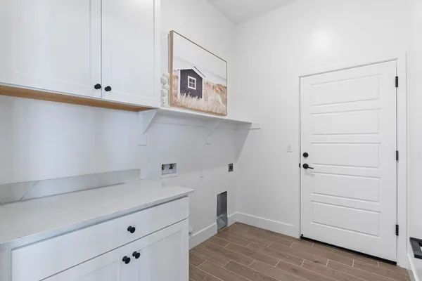 a view of cabinets and utility room with closet