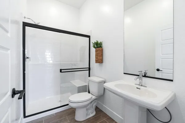 a white toilet sitting next to a bathroom sink