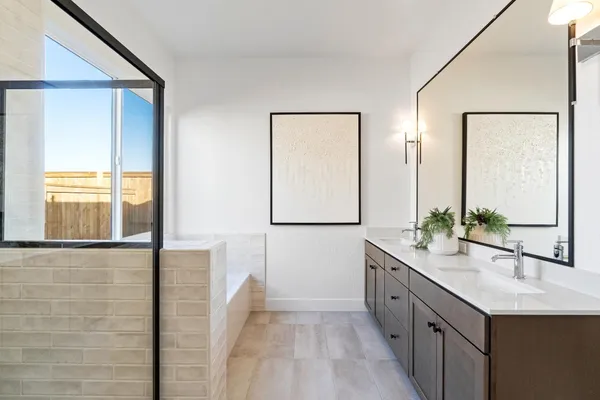a bathroom with a double vanity sink and mirror