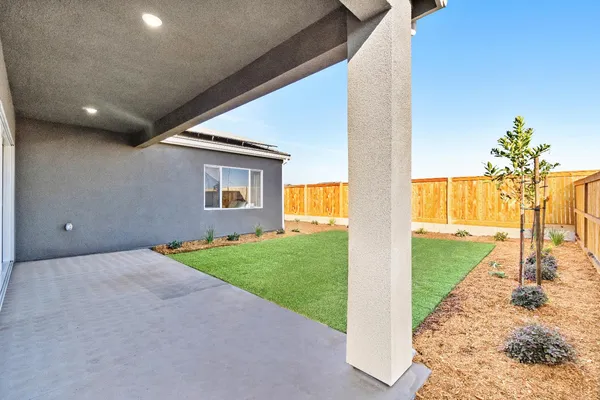 a view of a house with backyard and a small yard
