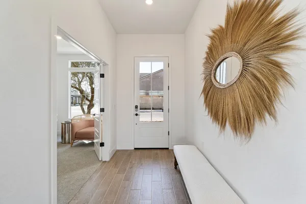 view of room with wooden floor and mirror