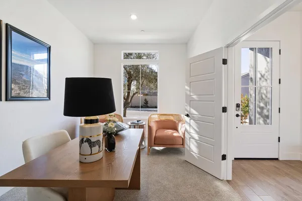 a living room with furniture a flat screen tv and a window