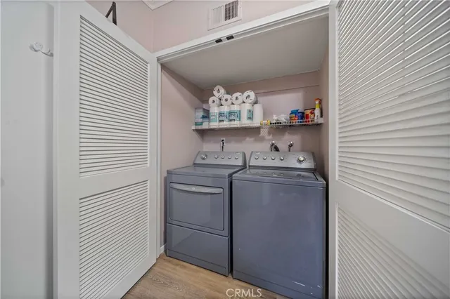 a kitchen with stainless steel appliances granite countertop a sink and a refrigerator