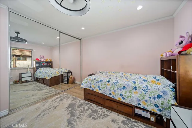 a bedroom with bed and mirror