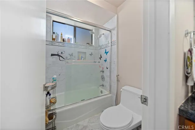 a bathroom with a toilet a sink and shower