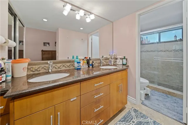 a bathroom with a sink double vanity and a shower