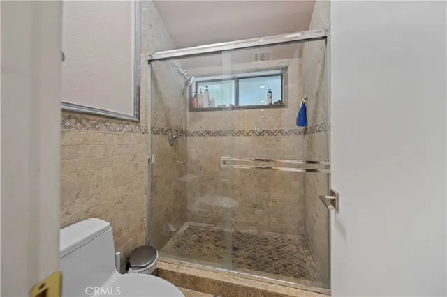 a bathroom with a shower and a toilet
