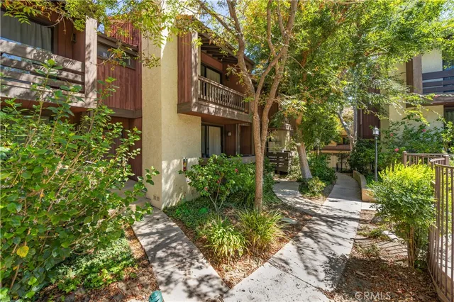a view of a pathway both side of the house