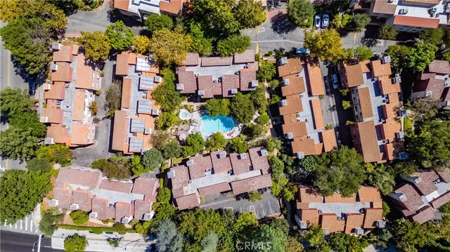 an aerial view of multiple houses with yard