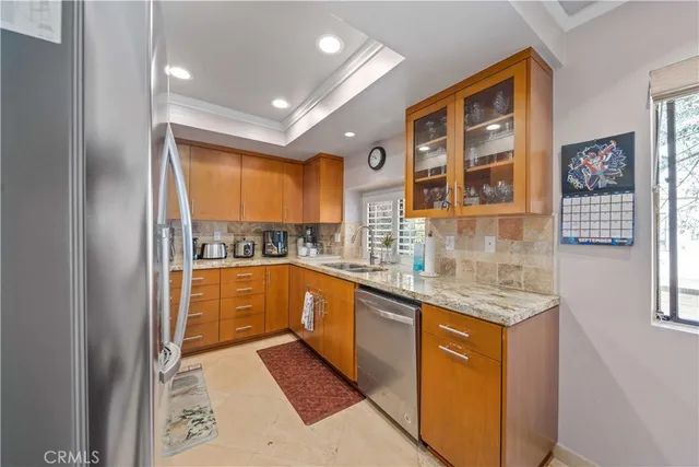 a kitchen with stainless steel appliances granite countertop a sink and cabinets