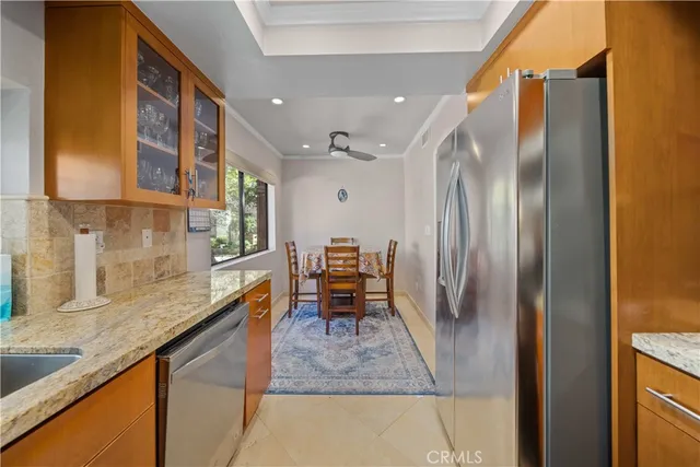 a kitchen with stainless steel appliances granite countertop a refrigerator and a sink
