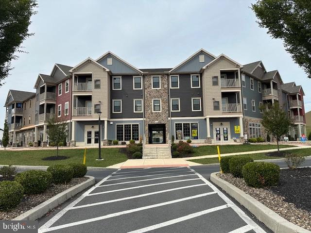a front view of a residential apartment building with a yard