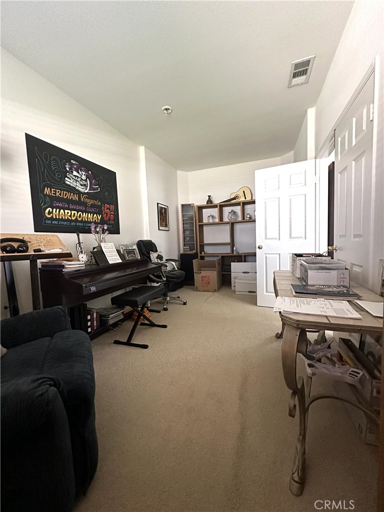 1665 Ravenswood Road Beaumont, CA 92223 - Photo 9 of 41 a living room with furniture a flat screen tv and a table
