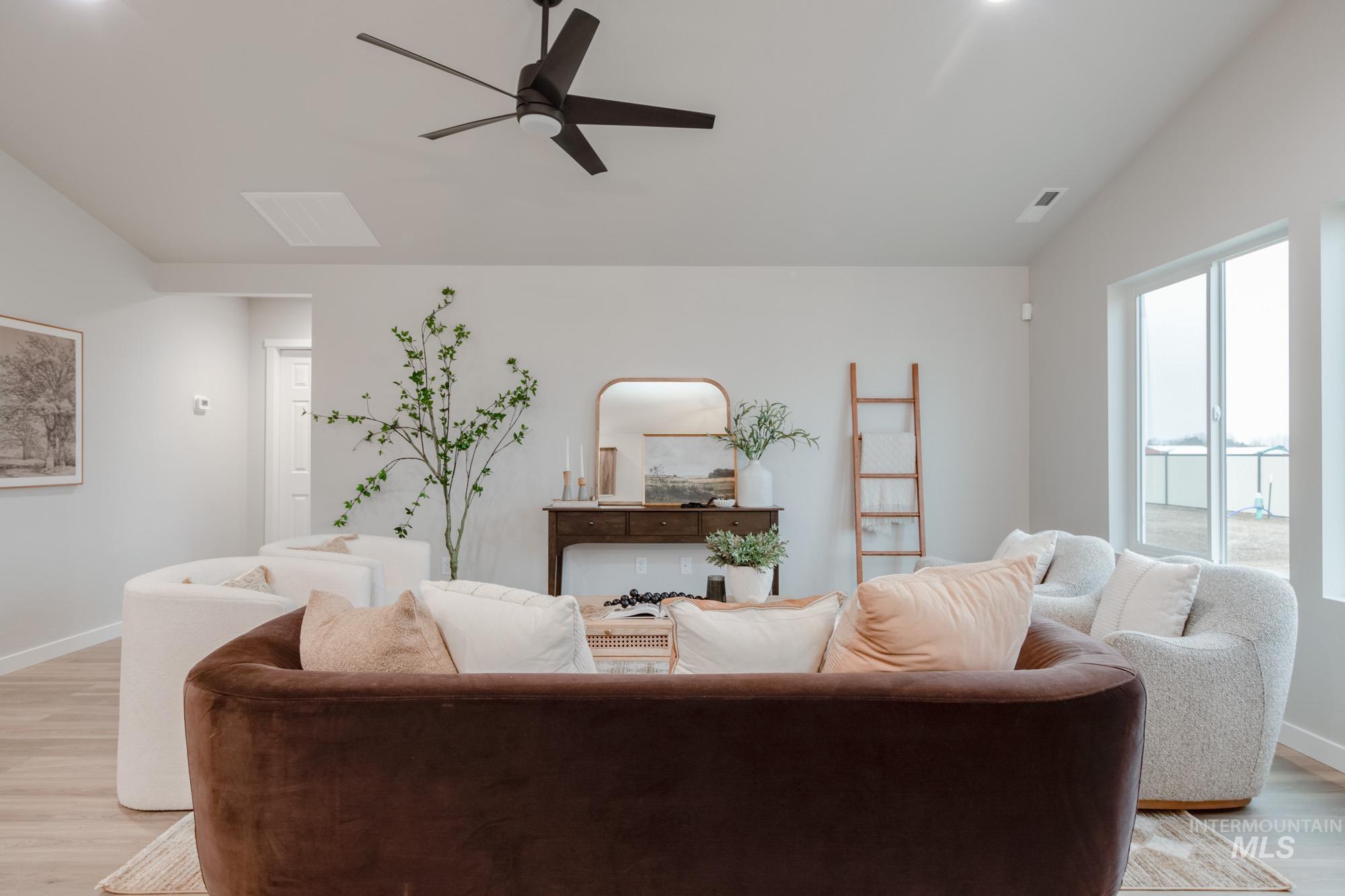 1760 West Unforgettable Street Meridian, ID 83642 - Photo 14 of 26 Living room featuring light wood-style floors, ceiling fan, and lofted ceiling