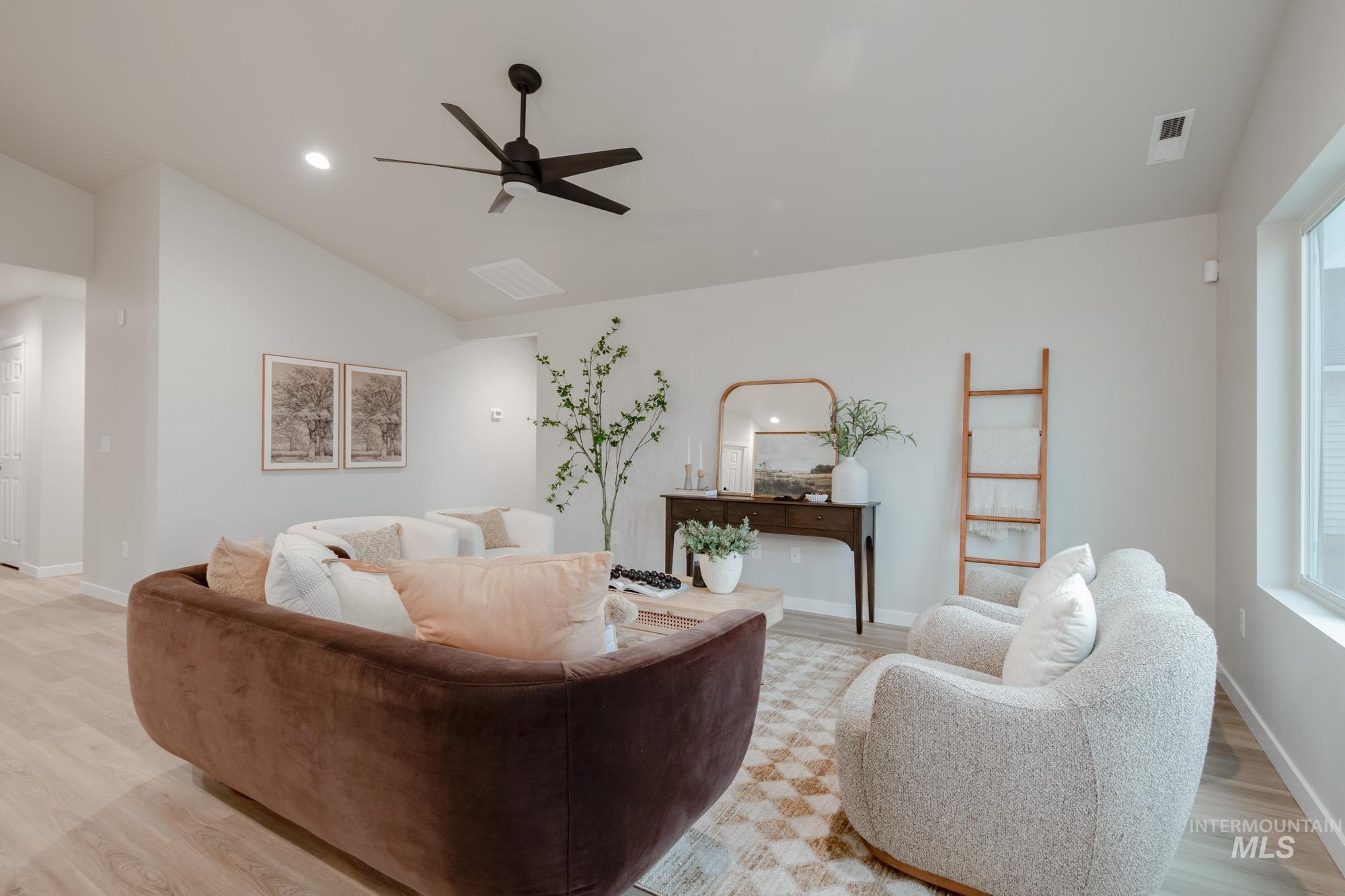 1760 West Unforgettable Street Meridian, ID 83642 - Photo 15 of 26 Living area with vaulted ceiling, light wood-style floors, ceiling fan, and recessed lighting
