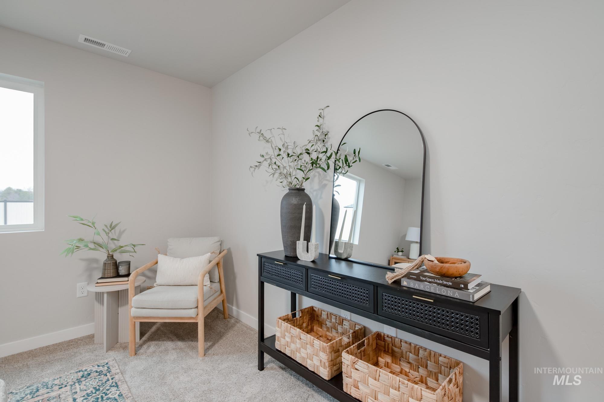1760 West Unforgettable Street Meridian, ID 83642 - Photo 18 of 26 Living area featuring light carpet and baseboards