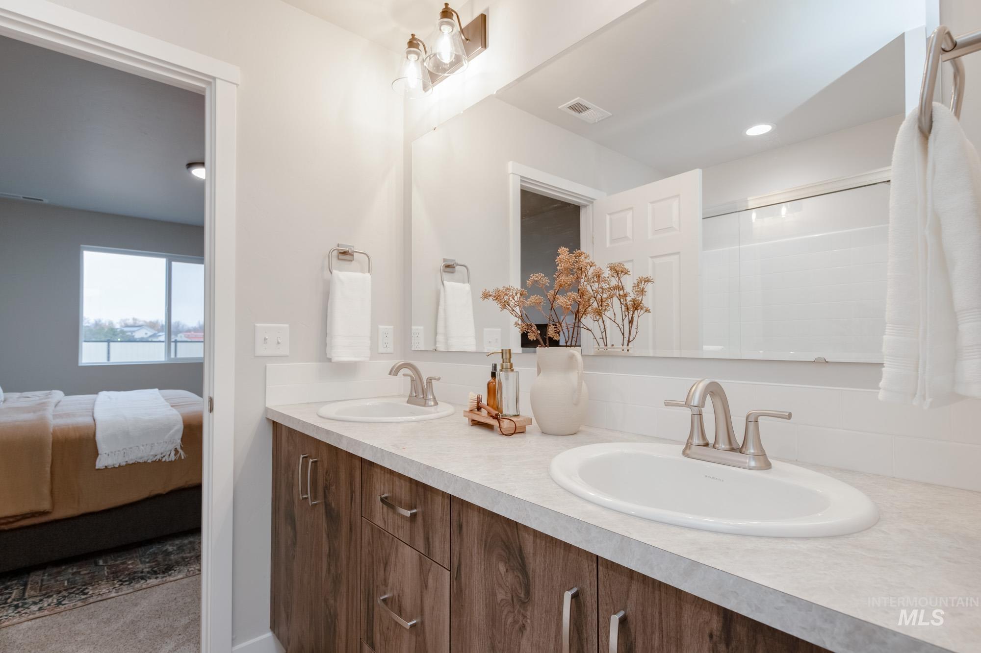 1760 West Unforgettable Street Meridian, ID 83642 - Photo 21 of 26 Bathroom with double vanity, ensuite bathroom, a shower stall, and recessed lighting