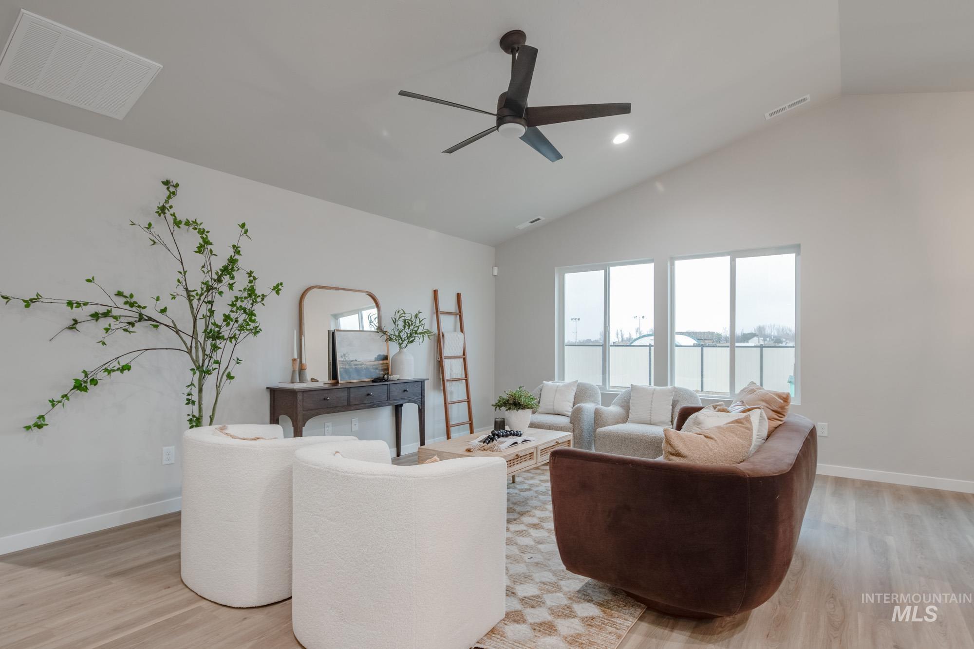 1760 West Unforgettable Street Meridian, ID 83642 - Photo 8 of 26 Living room featuring vaulted ceiling, light wood finished floors, a ceiling fan, and recessed lighting