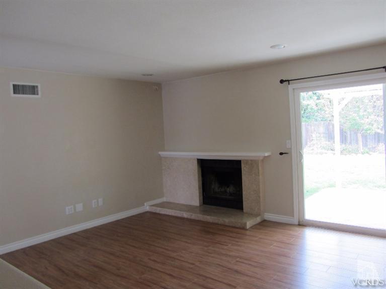 3192 Travis Avenue Simi Valley, CA 93063 - Photo 11 of 36 a view of empty room with wooden floor and fireplace