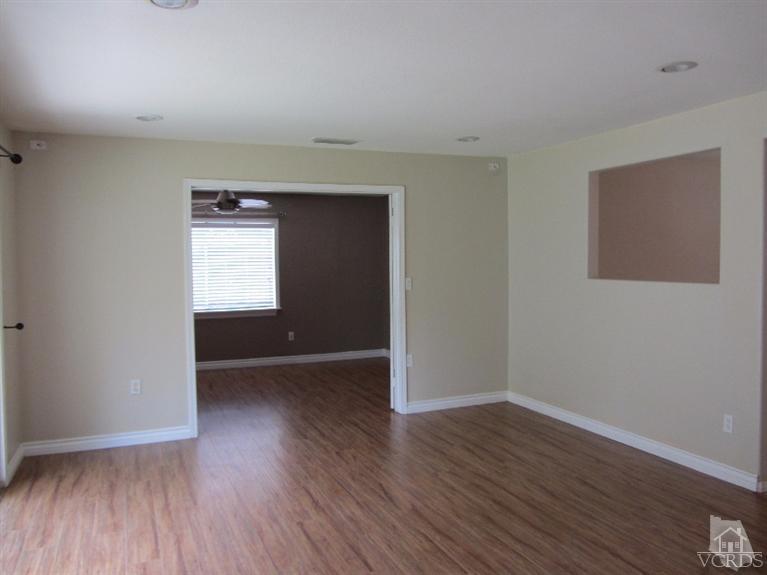 3192 Travis Avenue Simi Valley, CA 93063 - Photo 14 of 36 a view of an empty room with wooden floor and a window