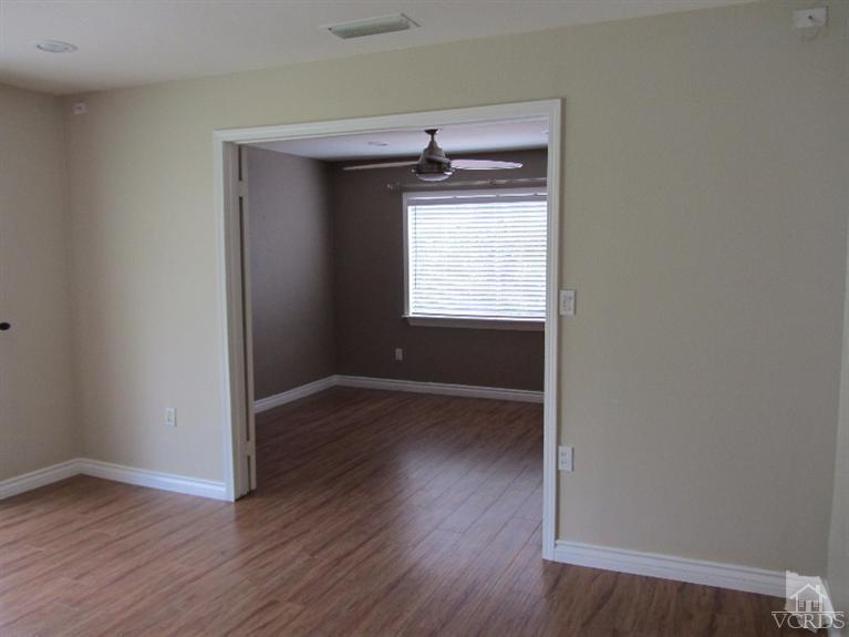3192 Travis Avenue Simi Valley, CA 93063 - Photo 15 of 36 an empty room with wooden floor and windows