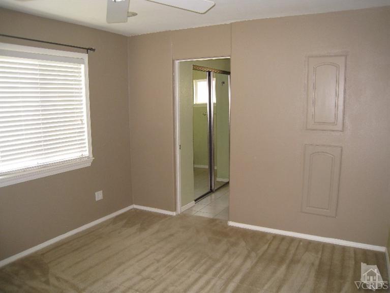 3192 Travis Avenue Simi Valley, CA 93063 - Photo 17 of 36 a view of an empty room with wooden floor and a window
