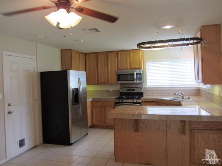3192 Travis Avenue Simi Valley, CA 93063 - Photo 3 of 36 a kitchen with a refrigerator a sink and dishwasher