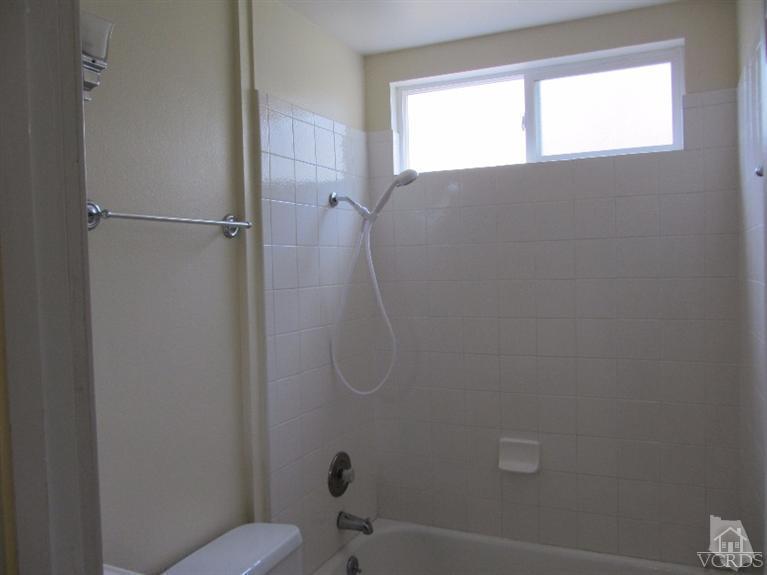 3192 Travis Avenue Simi Valley, CA 93063 - Photo 23 of 36 a bathroom with a granite countertop toilet and a shower