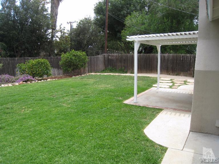 3192 Travis Avenue Simi Valley, CA 93063 - Photo 27 of 36 a view of a chair and tables in the grass