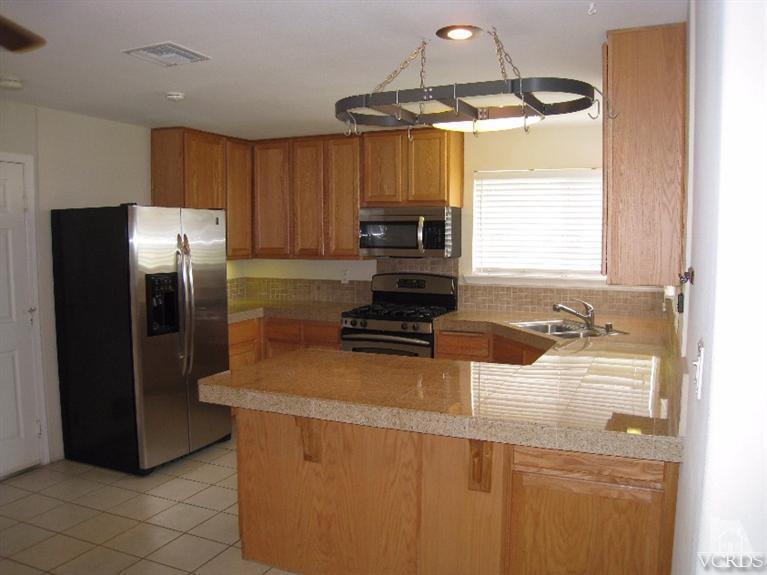 3192 Travis Avenue Simi Valley, CA 93063 - Photo 5 of 36 a kitchen with a refrigerator and a sink